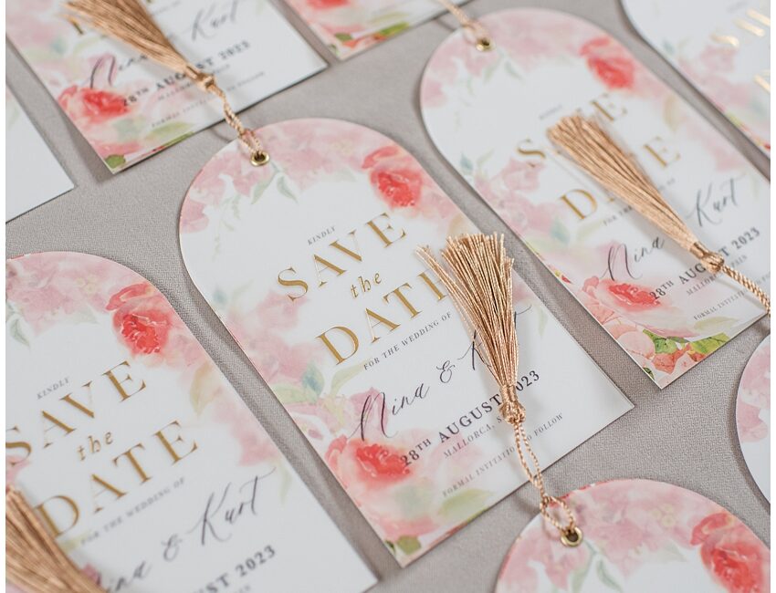 gold foil save the dates with gold tassel