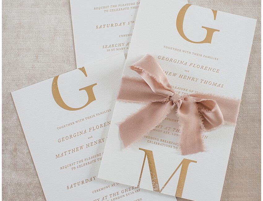 Minimal wedding invitations pressed in gold foil with silk ribbon for wedding at Searchy at The Gherkin, London
